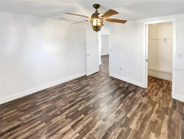 unfurnished room with ceiling fan and dark wood-type flooring