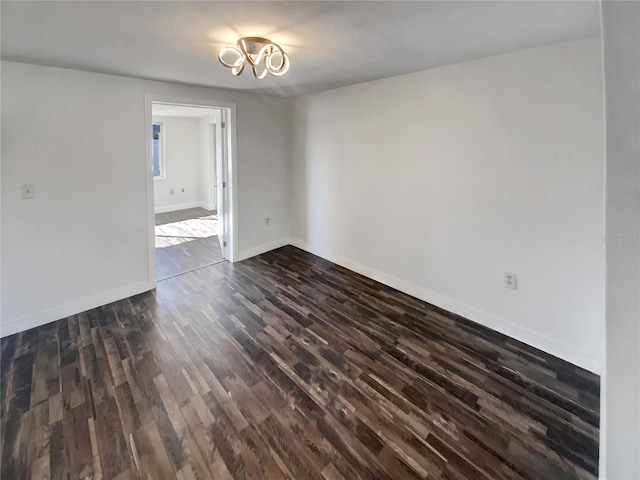 unfurnished room with dark hardwood / wood-style floors