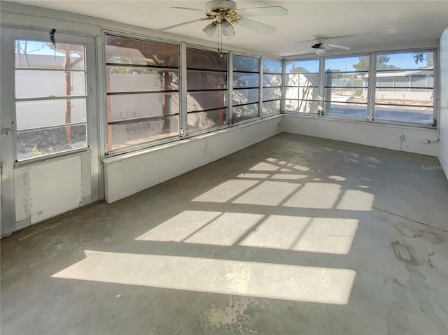 unfurnished sunroom featuring ceiling fan