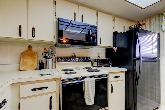 kitchen featuring white cabinets, tasteful backsplash, and black appliances