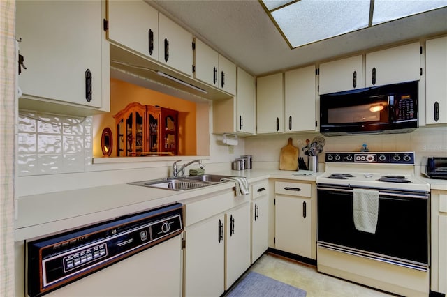 kitchen featuring white appliances, a toaster, a sink, light countertops, and backsplash