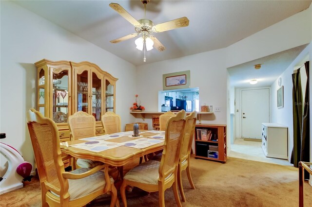 dining room with ceiling fan and light colored carpet