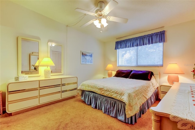 carpeted bedroom featuring lofted ceiling and ceiling fan