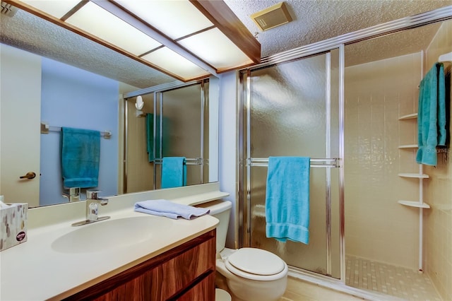 bathroom with vanity, toilet, and an enclosed shower