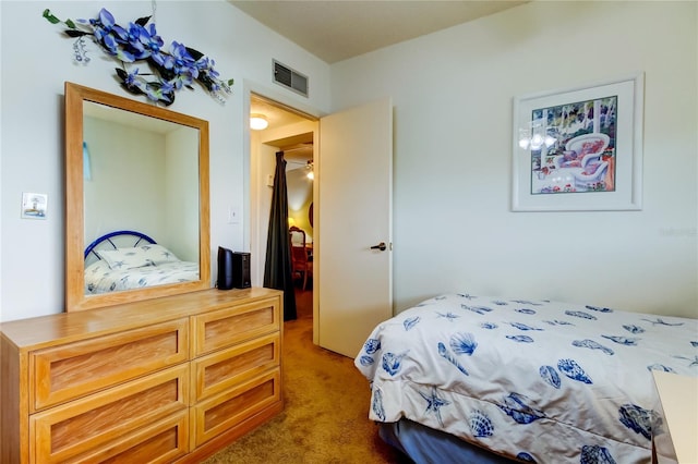 bedroom with visible vents and carpet flooring