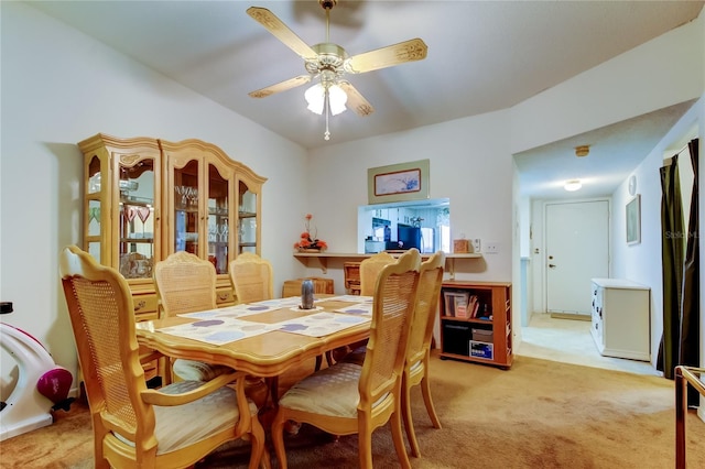 dining area with light colored carpet and ceiling fan