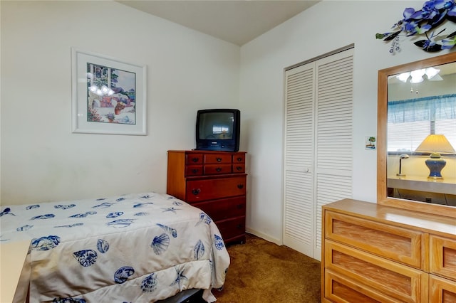 bedroom featuring a closet and dark colored carpet