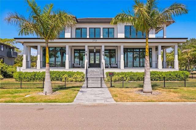 view of front facade with french doors and a front lawn