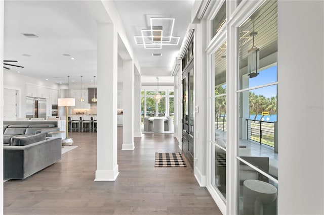 hallway featuring a healthy amount of sunlight and hardwood / wood-style flooring