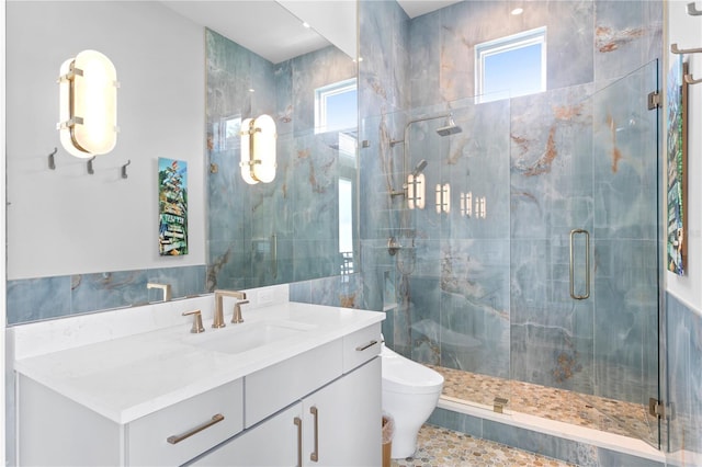 bathroom with a wealth of natural light, vanity, an enclosed shower, and toilet