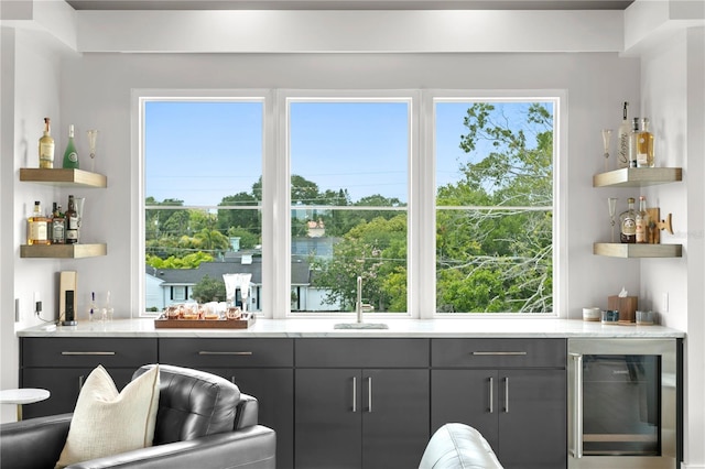 bar featuring gray cabinets, sink, and wine cooler