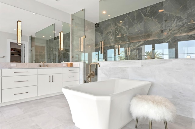 bathroom featuring vanity, tile walls, and independent shower and bath