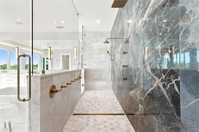 bathroom with vanity, tile walls, and a shower with shower door