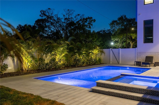 view of pool with an in ground hot tub