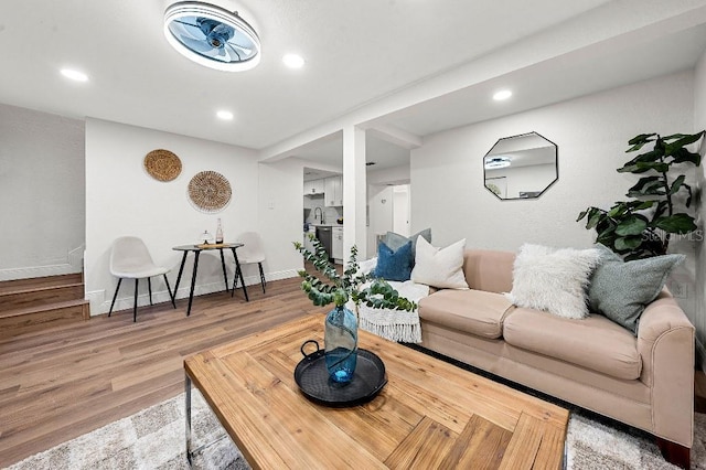 living room featuring hardwood / wood-style floors and sink