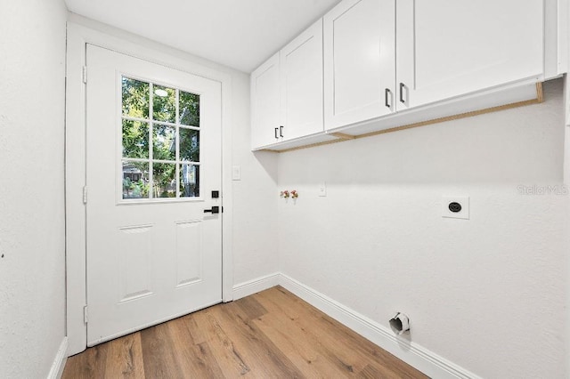 washroom with cabinets, light hardwood / wood-style floors, and hookup for an electric dryer