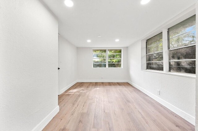 unfurnished room with light wood-type flooring