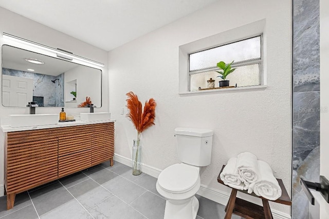 bathroom featuring tile patterned floors, vanity, and toilet