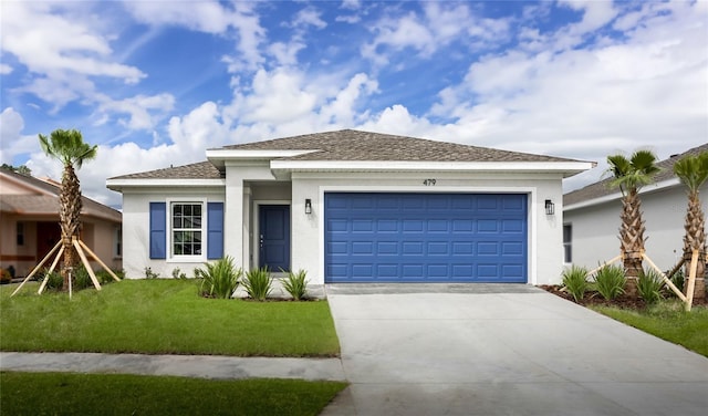 view of front of home with a garage and a front yard