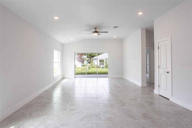 tiled spare room featuring ceiling fan and vaulted ceiling