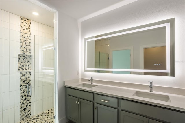 bathroom with a tile shower and vanity