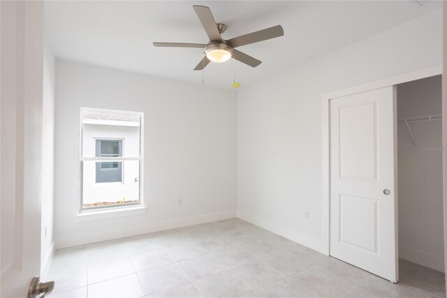479 Winwood Ct, Port Charlotte, FL 33954 - unfurnished bedroom featuring baseboards, a closet, light tile patterned floors, and ceiling fan