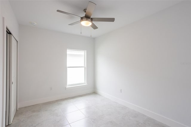 unfurnished bedroom featuring ceiling fan, light tile patterned floors, and a closet