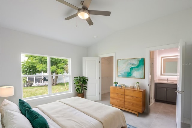 479 Winwood Ct, Port Charlotte, FL 33954 - bedroom with lofted ceiling, a sink, a spacious closet, light tile patterned floors, and ensuite bath