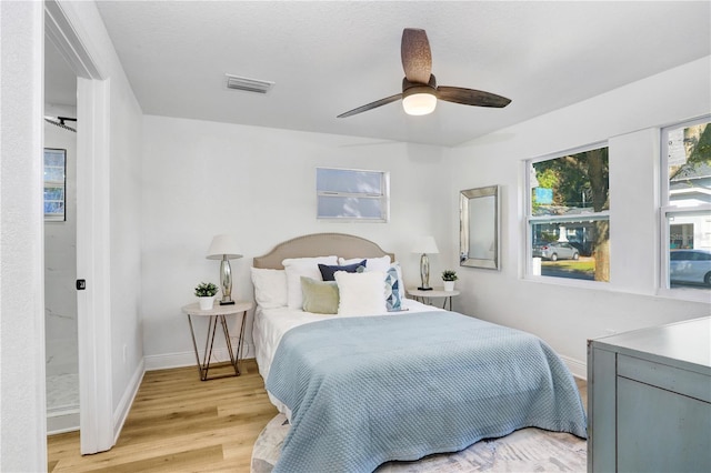 bedroom featuring ceiling fan, a textured ceiling, and light wood-type flooring