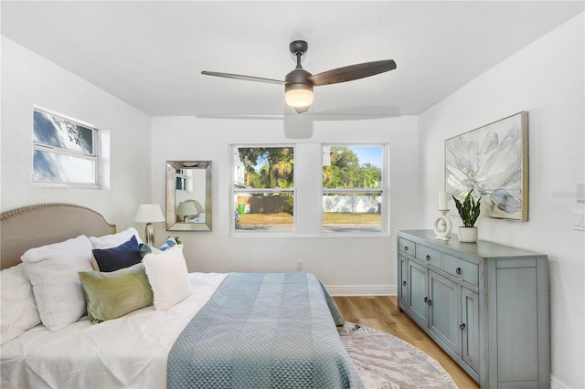 bedroom with ceiling fan and light wood-type flooring