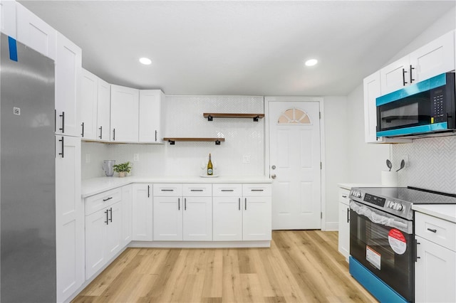 kitchen featuring backsplash, stainless steel appliances, light hardwood / wood-style floors, and white cabinets