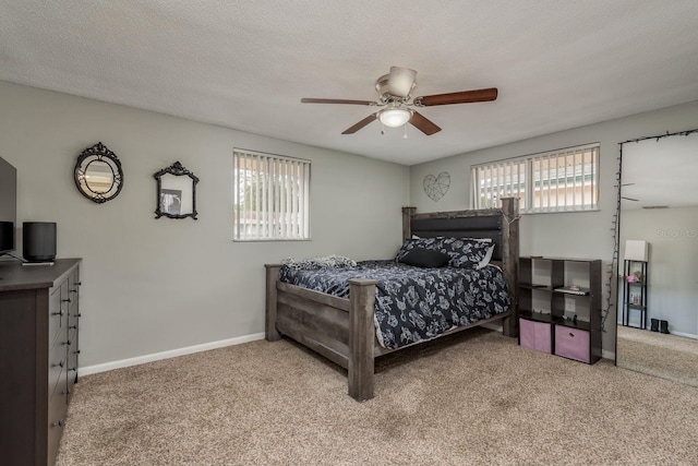 bedroom with carpet flooring, a textured ceiling, and ceiling fan