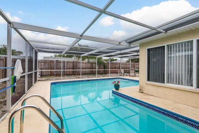 view of swimming pool featuring a lanai and a patio