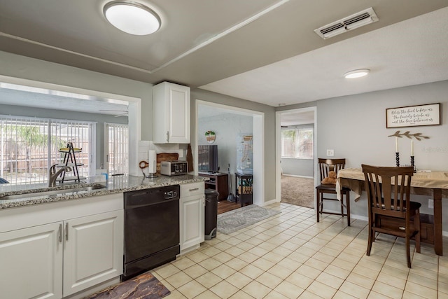 kitchen featuring dishwasher, white cabinets, sink, light stone countertops, and light tile patterned flooring