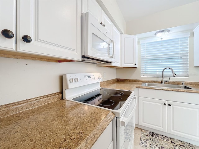 kitchen featuring white cabinetry, white appliances, sink, and light tile patterned floors