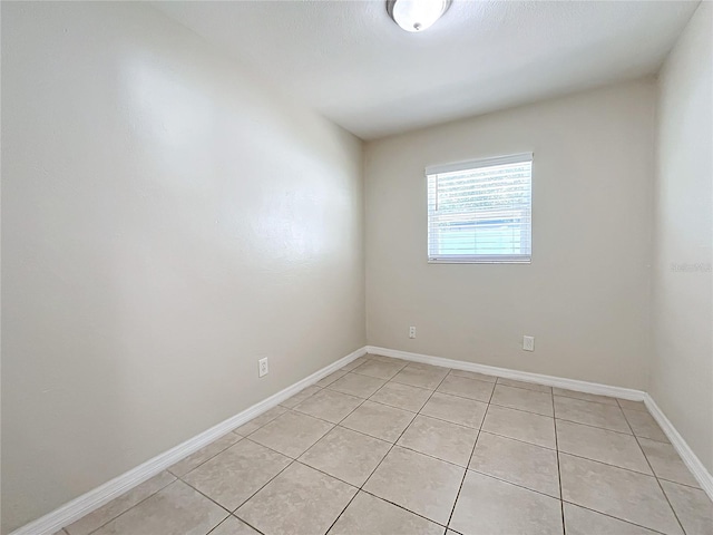 spare room featuring light tile patterned floors