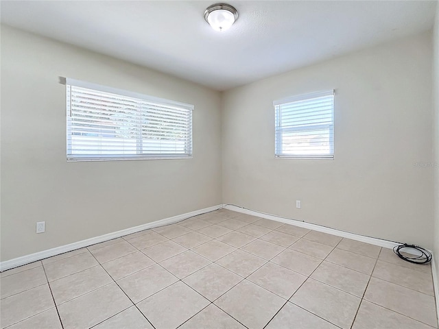 tiled empty room featuring a wealth of natural light