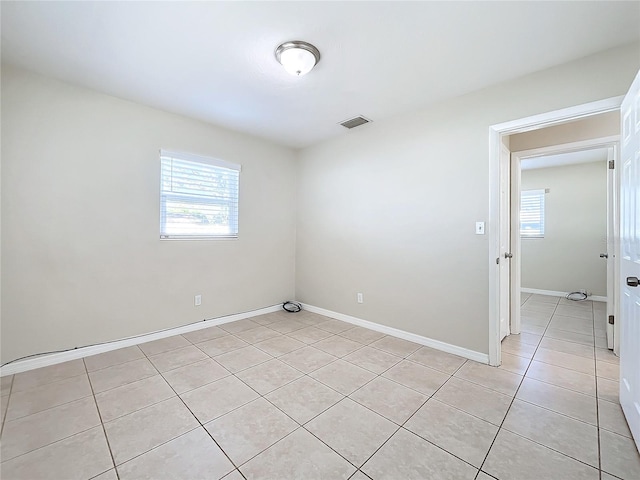 tiled empty room featuring a wealth of natural light