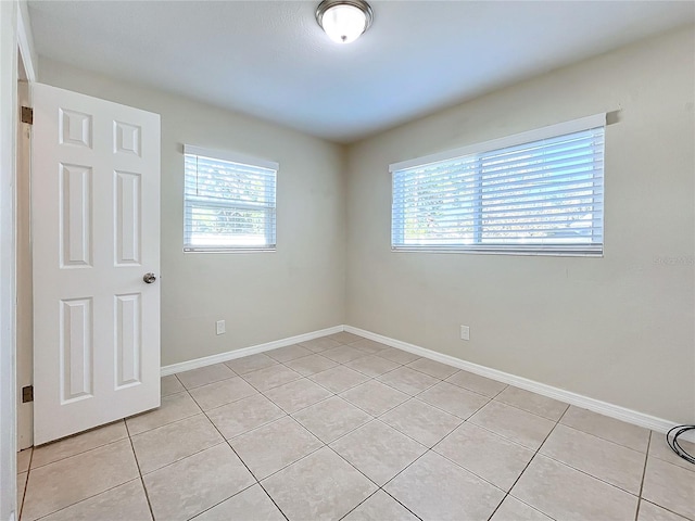 tiled spare room with a wealth of natural light