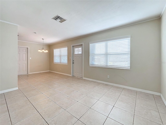 tiled empty room featuring crown molding and an inviting chandelier