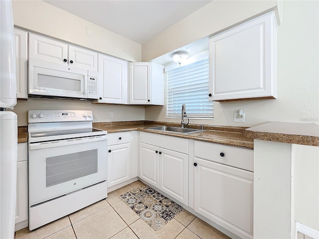 kitchen with sink, white cabinets, white appliances, and light tile patterned floors