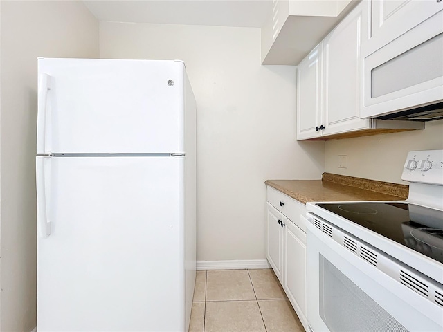 kitchen with white cabinets, white appliances, and light tile patterned flooring