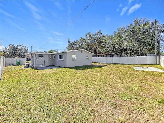 rear view of house featuring a lawn, a patio area, and central air condition unit