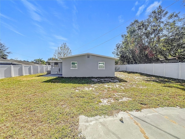 rear view of house with a yard