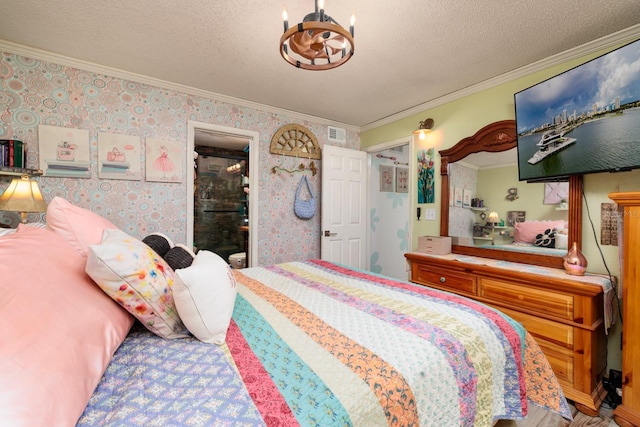 bedroom with a textured ceiling, crown molding, and a notable chandelier