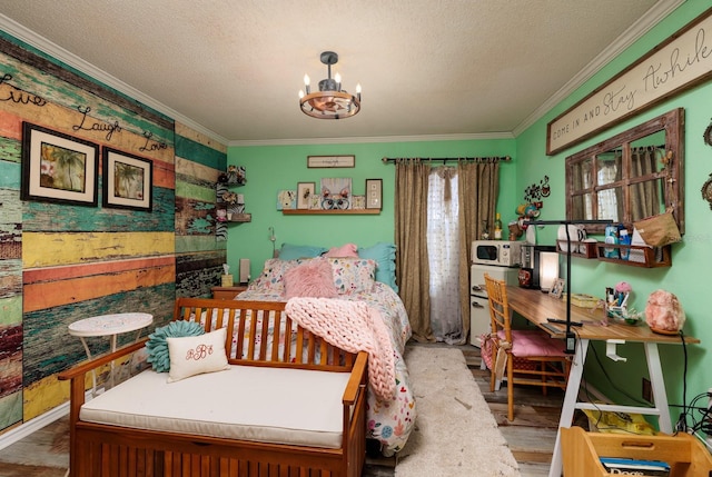 bedroom with ornamental molding, a chandelier, a textured ceiling, and hardwood / wood-style flooring