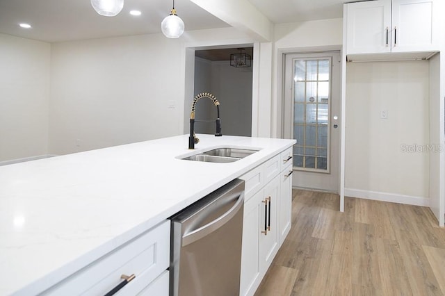 kitchen with white cabinetry, sink, stainless steel dishwasher, light hardwood / wood-style floors, and decorative light fixtures