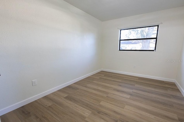 empty room featuring wood-type flooring