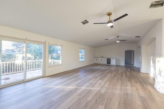 unfurnished living room featuring ceiling fan, light hardwood / wood-style floors, and vaulted ceiling