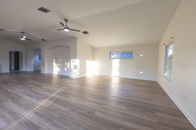 spare room featuring hardwood / wood-style floors, ceiling fan, and vaulted ceiling